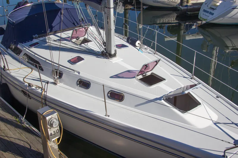 Slide: The Image of 2008 Catalina 42 MkII sailboat docked at marina, featuring open hatches and sleek design. - 31