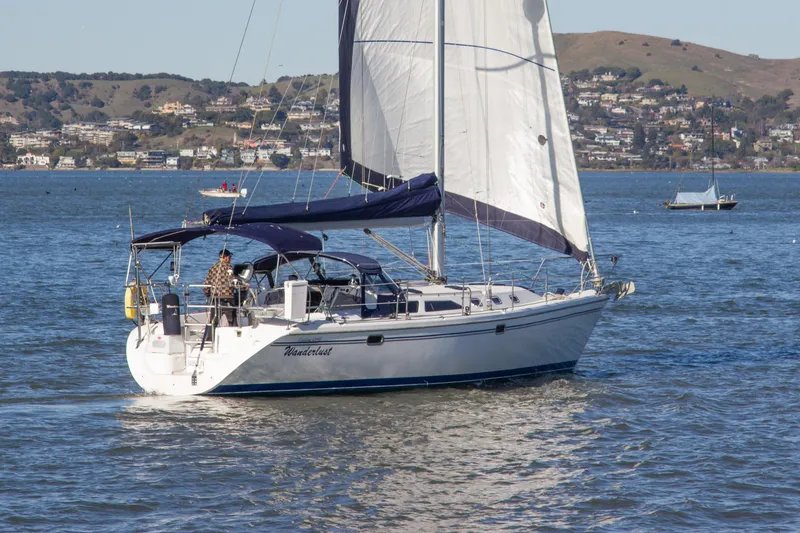 Slide: The Image of 2008 Catalina 42 MkII sailboat cruising on a scenic lake with hills in the background. - 5