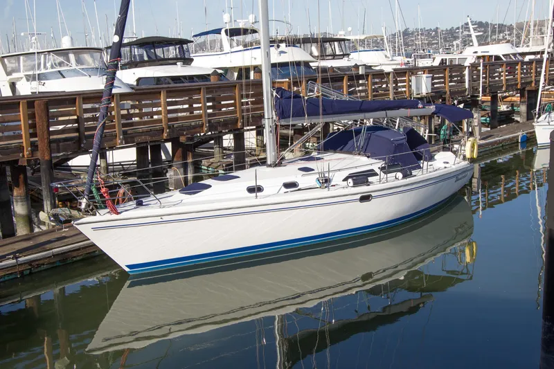 Slide: The Image of 2008 Catalina 42 MkII sailboat docked at marina, reflecting on calm water. - 6