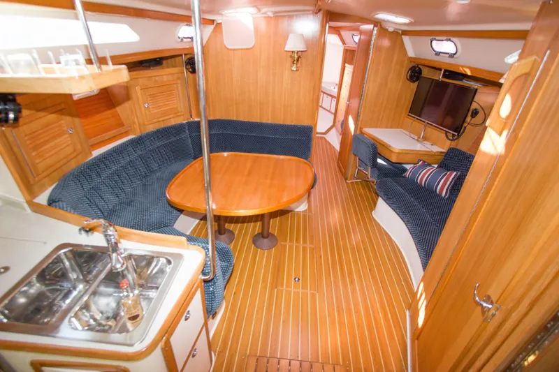 Slide: The Image of Interior of 2008 Catalina 42 MkII sailboat with cozy seating and wooden finishes. - 9