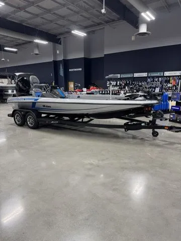 The Image of 2026 Ikon Boats LXL20 on trailer in showroom, sleek design, modern features. - 1