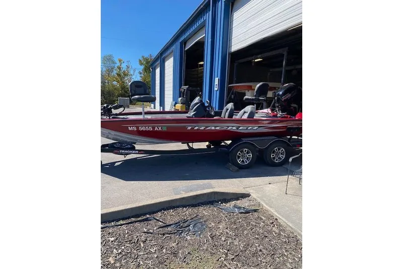 Slide: The Image of 2021 Bass Tracker Pro Team 195 TXW Team Edition boat parked outside a blue garage. - 5