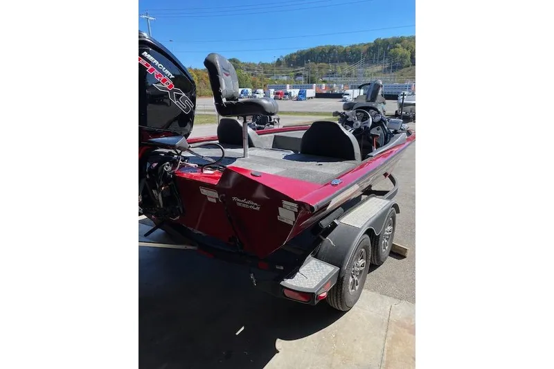 Slide: The Image of 2021 Bass Tracker Pro Team 195 TXW Team Edition boat on trailer, red exterior. - 7