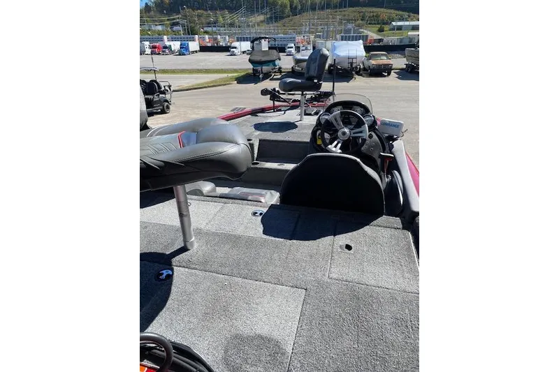 Slide: The Image of 2021 Bass Tracker Pro Team 195 TXW Team Edition boat interior with steering wheel and seating. - 8