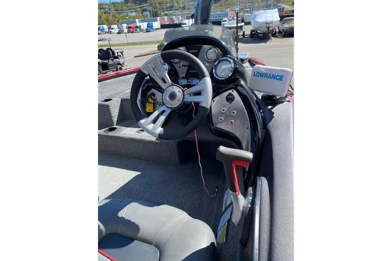 Slide: The Image of 2021 Bass Tracker Pro Team 195 TXW Team Edition boat cockpit with steering wheel and Lowrance device. - 9