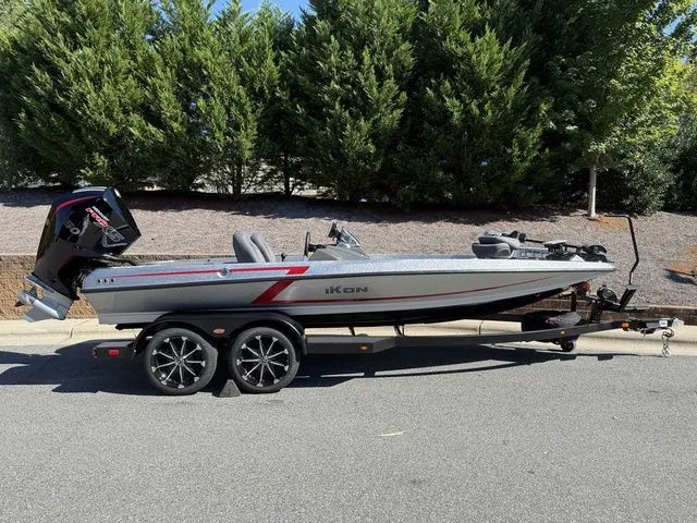 The Image of 2026 Ikon Boats VLX20 on trailer, parked on road with trees in background. - 1