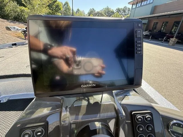 Slide: The Image of Garmin display on 2026 Ikon Boats VLX20 dashboard, reflecting surroundings. - 8