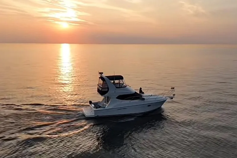 The Image of 2005 Silverton 34 Convertible yacht docked at marina under clear blue sky. - 0