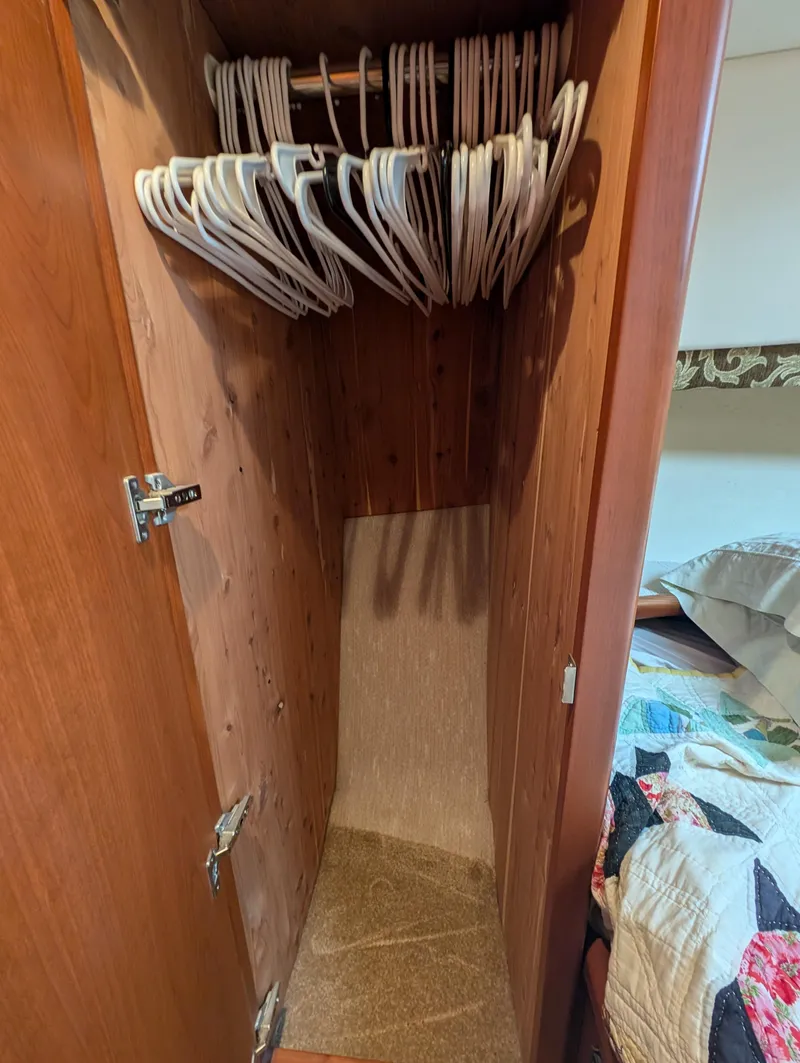 Slide: The Image of 2005 Silverton 34 Convertible boat deck at marina, featuring spacious layout and docked vessels. - 11