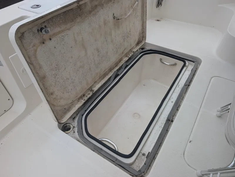 Slide: The Image of 2005 Silverton 34 Convertible yacht interior with white seating at marina. - 13