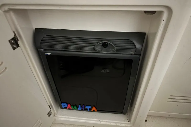 Slide: The Image of Interior of 2005 Silverton 34 Convertible yacht with beige seating and wooden table. - 18