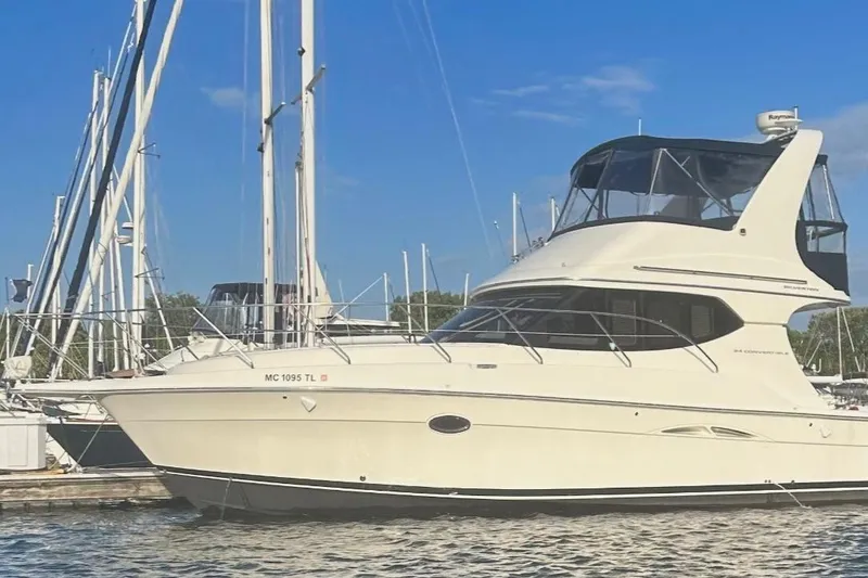 Slide: The Image of 2005 Silverton 34 Convertible boat helm with steering wheel and navigation instruments. - 2