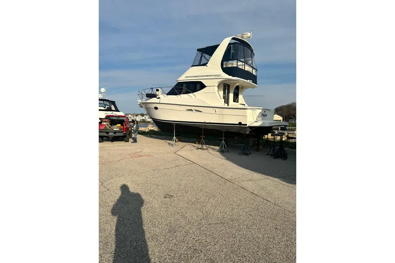 Slide: The Image of Interior of a 2005 Silverton 34 Convertible yacht with kitchen and seating area. - 3