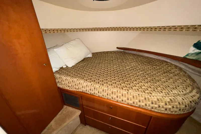 Slide: The Image of Interior of 2005 Silverton 34 Convertible boat with white seating and nautical decor. - 31