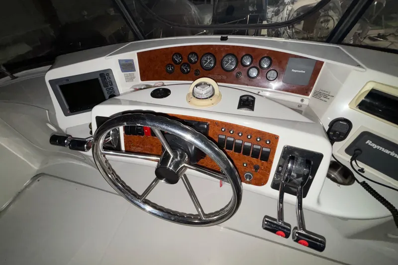 Slide: The Image of Engine compartment of a 2005 Silverton 34 Convertible boat, showing mechanical components and wiring. - 48