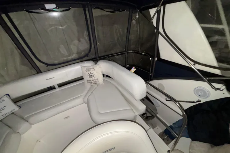 Slide: The Image of 2005 Silverton 34 Convertible yacht docked in a marina, surrounded by calm waters. - 50