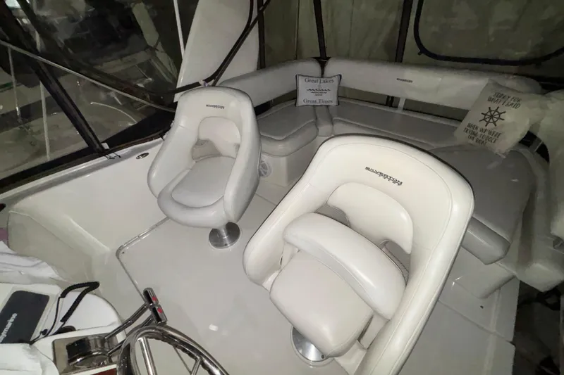 Slide: The Image of 2005 Silverton 34 Convertible yacht docked in a marina under clear blue skies. - 51