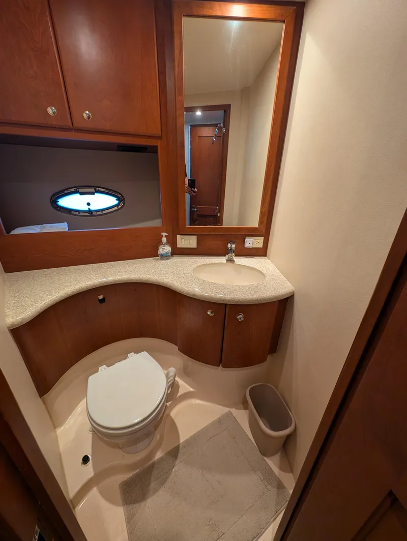 Slide: The Image of 2005 Silverton 34 Convertible yacht bathroom with modern fixtures and wood cabinetry. - 9
