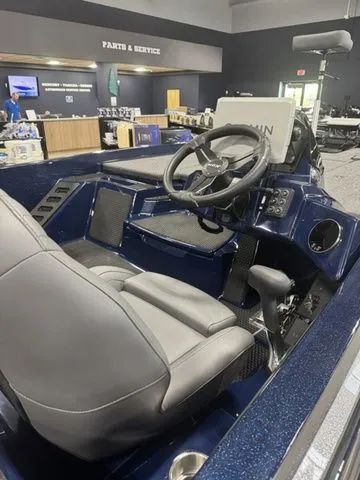 Slide: The Image of 2026 Ikon Boats VLX20 interior with steering wheel and seating in showroom. - 3