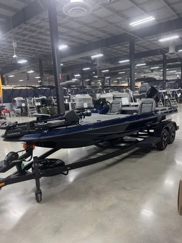 Slide: The Image of 2026 Ikon Boats VLX20 in showroom, sleek design, advanced features, on trailer. - 2