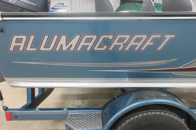 Slide: The Image of 2013 Alumacraft Competitor 175 SC boat on trailer, blue exterior with logo. - 14