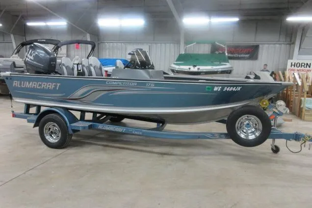 Slide: The Image of 2013 Alumacraft Competitor 175 SC boat on trailer in indoor showroom. - 3