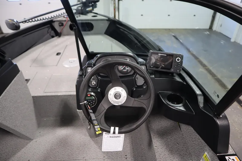 Slide: The Image of 2026 Crestliner 1850 Kodiak WT boat interior with steering wheel and navigation system. - 22