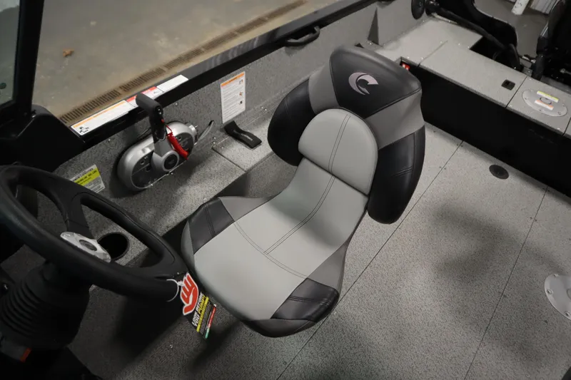 Slide: The Image of 2026 Crestliner 1850 Kodiak WT boat interior with steering wheel and cushioned seat. - 30