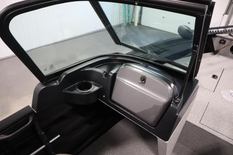 Slide: The Image of 2026 Crestliner 1850 Kodiak WT boat interior with windshield and storage compartment. - 31