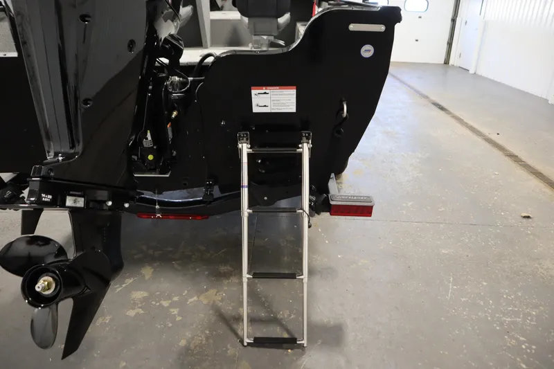 Slide: The Image of 2026 Crestliner 1850 Kodiak WT boat with ladder and propeller in a garage setting. - 39