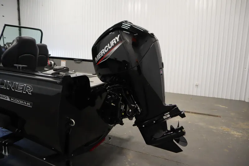 Slide: The Image of 2026 Crestliner 1850 Kodiak WT boat with Mercury outboard motor in a garage. - 40