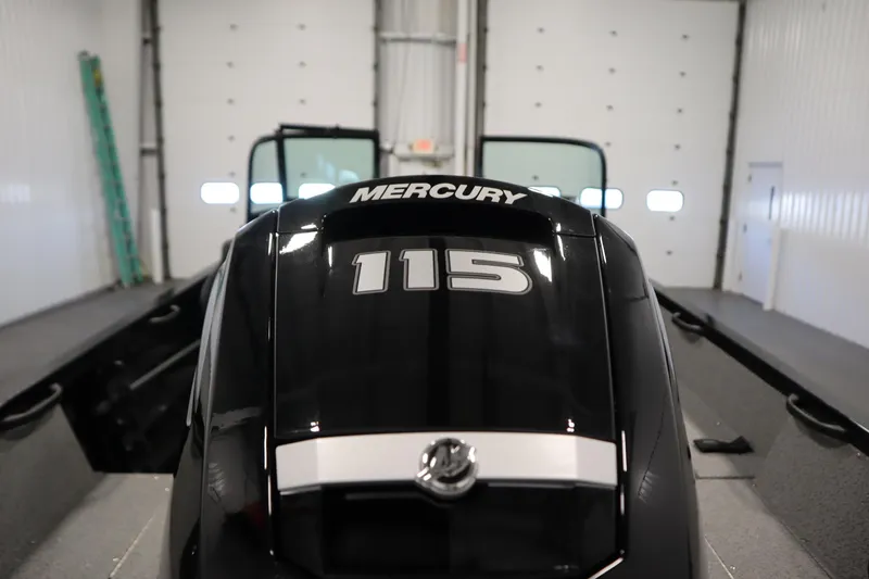 Slide: The Image of 2026 Crestliner 1850 Kodiak WT with Mercury 115 engine in a garage. - 42