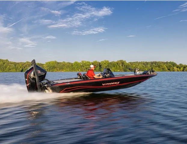 The Image of 2026 Phoenix Bass Boats 721 ZXL speeding on a lake under a clear blue sky. - 1