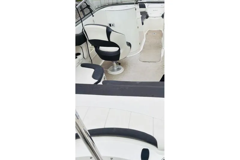 Slide: The Image of 2018 Stingray 214 LR boat interior with seating and helm area. - 5