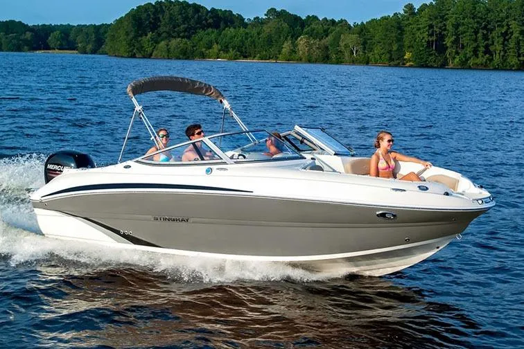Slide: The Image of Manufacturer Provided Image: 2018 Stingray 214 LR boat cruising on a lake with passengers. - 6