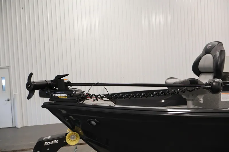 Slide: The Image of 2026 Crestliner 1850 Kodiak SC boat with Minn Kota trolling motor in a showroom. - 10