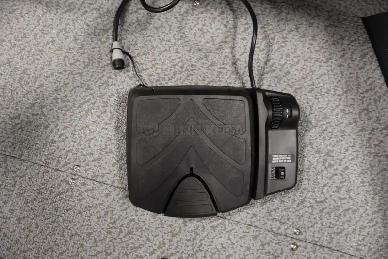Slide: The Image of Minn Kota foot pedal on 2026 Crestliner 1850 Kodiak SC boat's carpeted floor. - 13