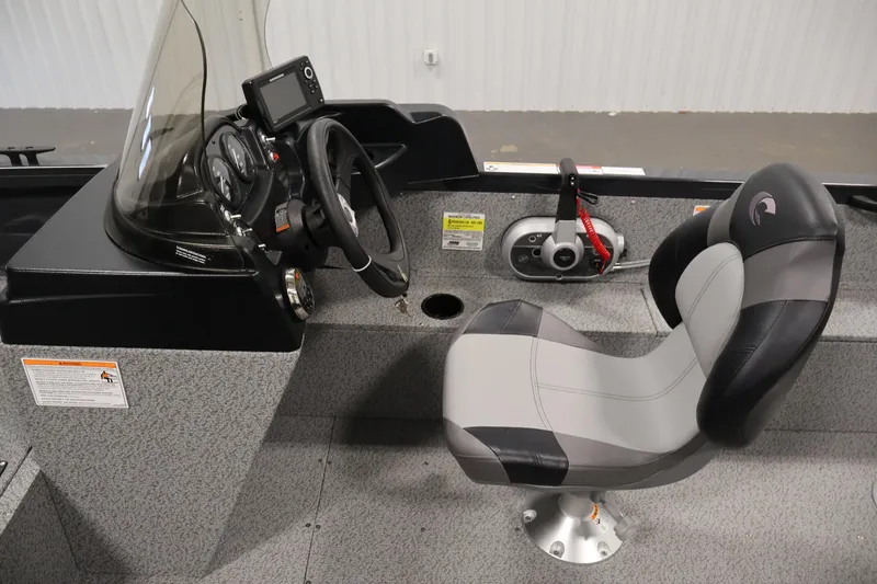 Slide: The Image of 2026 Crestliner 1850 Kodiak SC boat interior with steering console and captain's chair. - 18