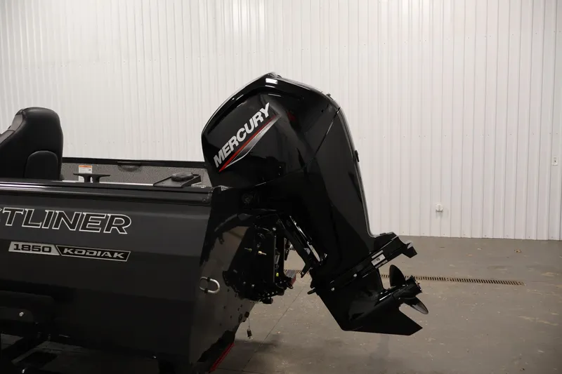 Slide: The Image of 2026 Crestliner 1850 Kodiak SC boat with Mercury outboard motor in a garage. - 29