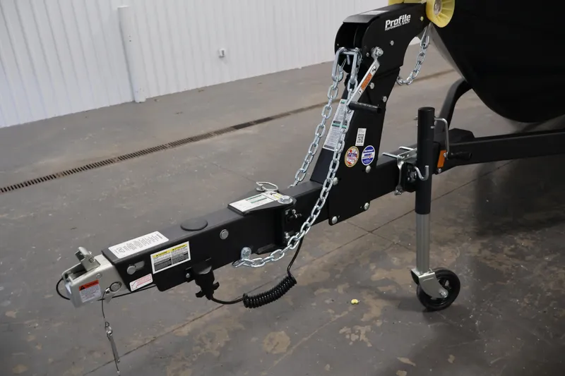 Slide: The Image of Trailer hitch of 2026 Crestliner 1850 Kodiak SC boat, featuring secure chains and wheel support. - 32