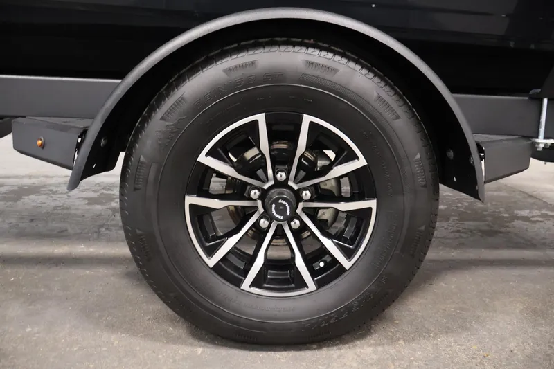 Slide: The Image of 2026 Crestliner 1850 Kodiak SC trailer wheel with black alloy rim. - 34