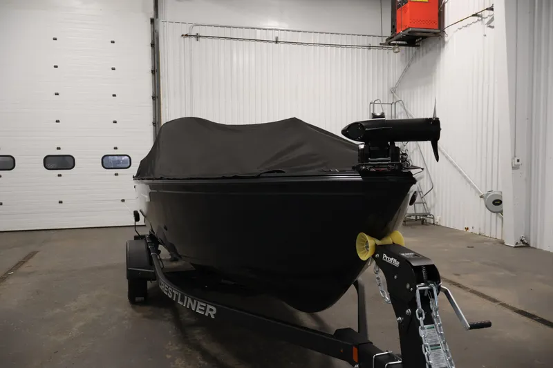 Slide: The Image of 2026 Crestliner 1850 Kodiak SC boat covered in a garage, on a trailer. - 35