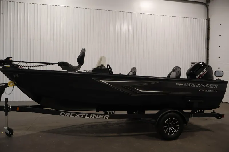 Slide: The Image of 2026 Crestliner 1850 Kodiak SC fishing boat on trailer in indoor setting. - 7