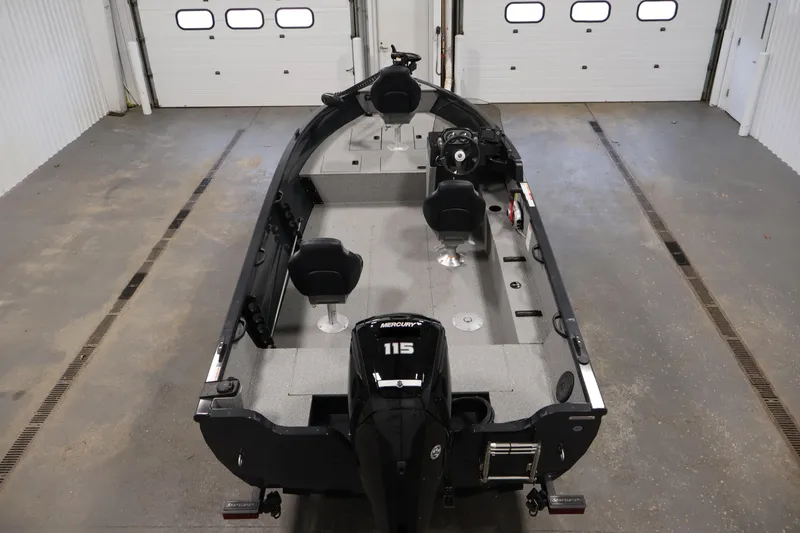 Slide: The Image of 2026 Crestliner 1850 Kodiak SC fishing boat in a garage, featuring a Mercury 115 engine. - 9