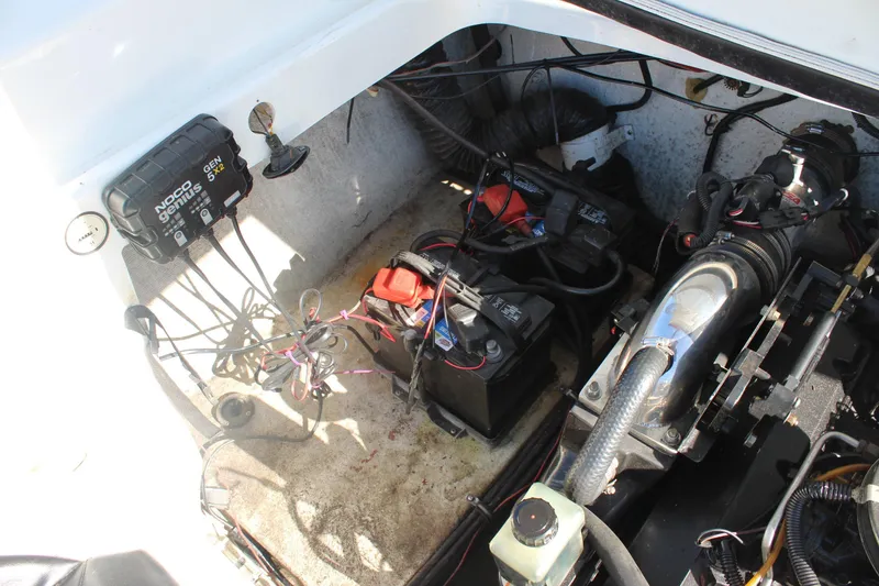 Slide: The Image of Engine compartment of a 1996 Baja 232 boat with batteries and wiring. - 13