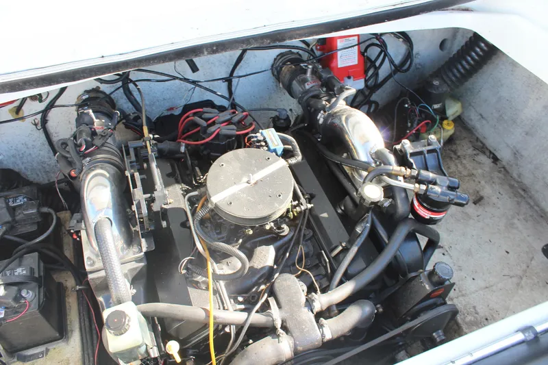 Slide: The Image of Engine compartment of a 1996 Baja 232 boat, showcasing mechanical components. - 14