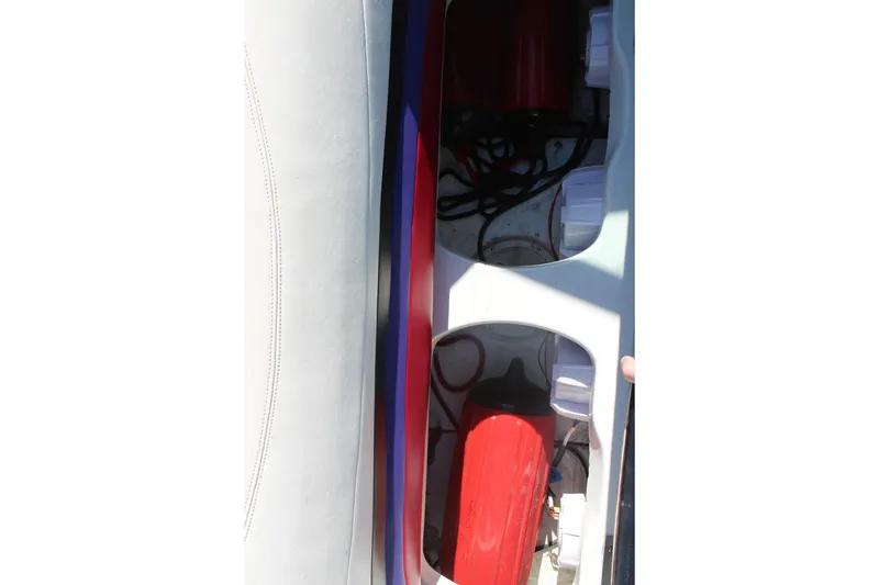 Slide: The Image of Interior view of a 1996 Baja 232 boat showing storage compartments and equipment. - 15