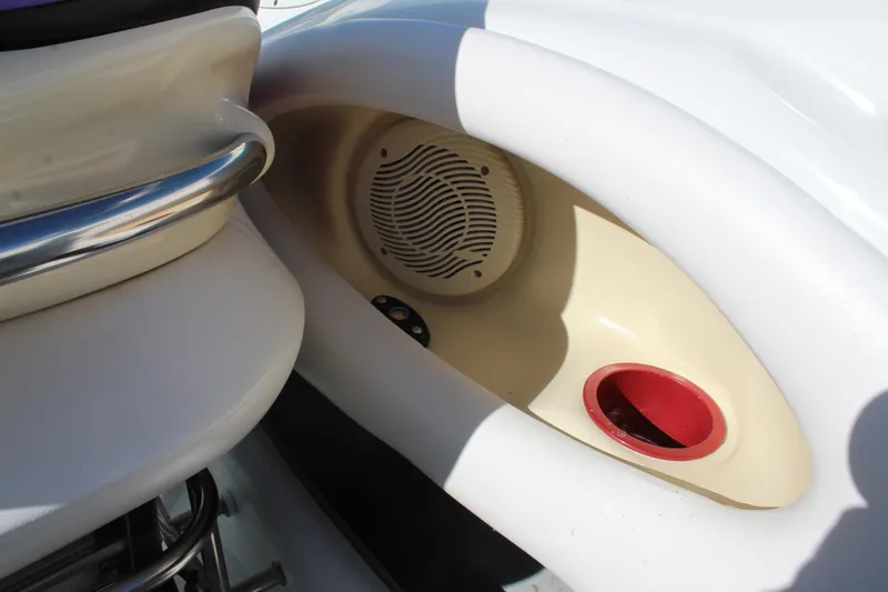 Slide: The Image of 1996 Baja 232 boat interior with speaker and cup holder detail. - 21