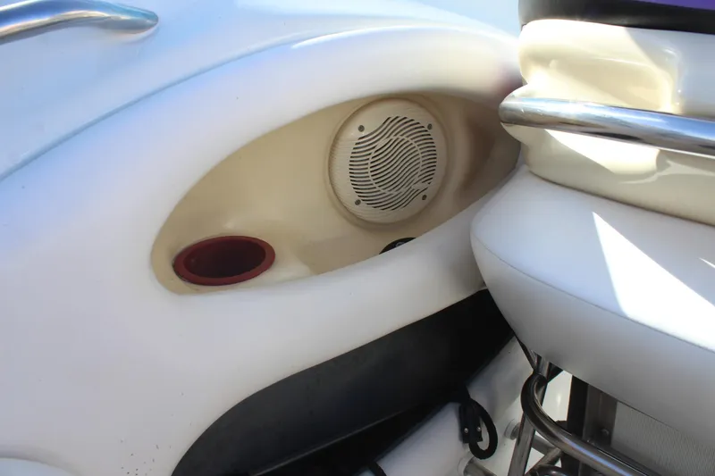 Slide: The Image of Interior of a 1996 Baja 232 boat featuring a speaker and cup holder. - 22
