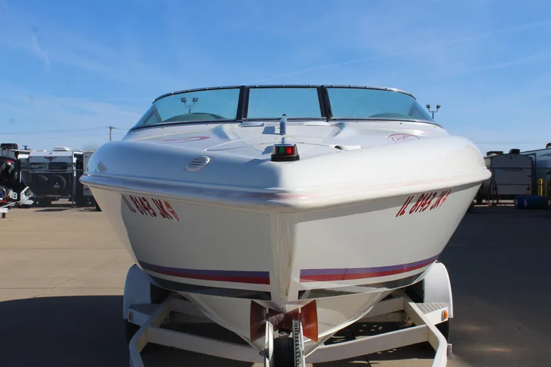 Slide: The Image of 1996 Baja 232 speedboat on trailer, front view, clear sky background. - 3